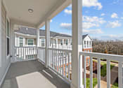 Thumbnail 39 of 39 - A balcony with white railings and a view of a residential area.