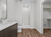 Thumbnail 8 of 42 - A bathroom with a toilet, sink, and marble wall.