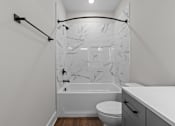 Thumbnail 17 of 37 - A white bathroom with a marble shower.