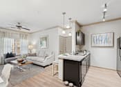 Thumbnail 5 of 41 - A modern kitchen with a white sofa and a black refrigerator.