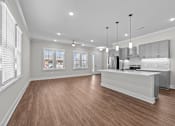 Thumbnail 15 of 37 - A spacious kitchen with wooden floors and a large island.