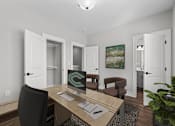 Thumbnail 8 of 37 - A room with a desk, chair, and a painting on the wall.