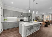 Thumbnail 3 of 37 - A modern kitchen with a large island and bar stools.