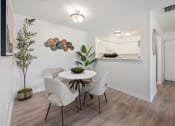 Thumbnail 18 of 27 - a dining room with a table and chairs    and a kitchen
