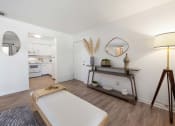 Thumbnail 20 of 27 - a bedroom with a bed and a lamp and a kitchen