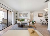 Thumbnail 16 of 27 - a living room with a white couch and a sliding glass door