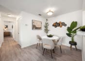 Thumbnail 19 of 27 - our apartments offer a dining room with white chairs and a table