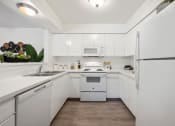 Thumbnail 23 of 27 - the preserve at ballantyne commons apartment kitchen with white appliances