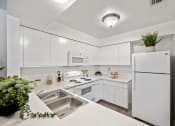 Thumbnail 21 of 27 - the preserve at ballantyne commons apartment kitchen with white cabinets and stainless steel appliances