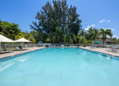 Thumbnail 3 of 27 - a swimming pool at a resort with palm trees