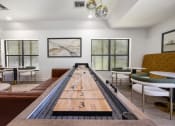 Thumbnail 5 of 27 - a room with a shuffleboard table in the center of it