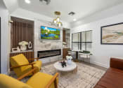 Thumbnail 6 of 27 - a living room with yellow furniture and a fireplace