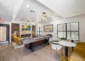 Thumbnail 4 of 27 - a game room with a pool table and chairs