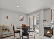 Thumbnail 3 of 21 - a living room with a fireplace and a table and chairs