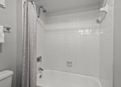 Thumbnail 8 of 21 - a bathroom with a white tub and a white tiled shower