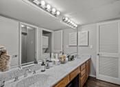 Thumbnail 7 of 21 - a bathroom with a large mirror and a double sink