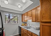 Thumbnail 4 of 21 - a kitchen with wooden cabinets and a sink and a window