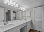 Thumbnail 12 of 21 - a bathroom with a large sink and a mirror