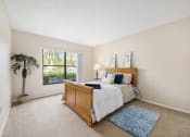 Thumbnail 18 of 27 - a bedroom with a bed and a window