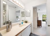 Thumbnail 19 of 27 - a bathroom with a sink and a mirror