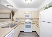 Thumbnail 13 of 27 - a kitchen with a refrigerator freezer and a stove top oven