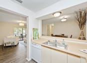 Thumbnail 30 of 46 - a kitchen with white cabinetry and a white dishwasher