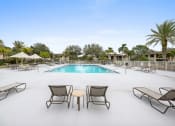 Thumbnail 1 of 46 - a swimming pool with lounge chairs and tables