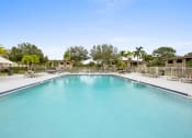 Thumbnail 3 of 46 - a large swimming pool with lounge chairs and umbrellas