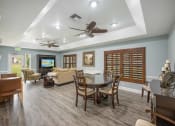 Thumbnail 16 of 46 - a living room and dining room with blue walls and a coffered ceiling