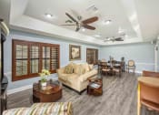 Thumbnail 14 of 46 - a living room with a couch a table and a ceiling fan