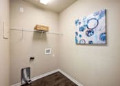 Thumbnail 31 of 39 - A room with a basket on a shelf and a painting on the wall.