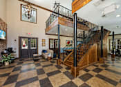 Thumbnail 5 of 39 - A large room with a checkered floor and a staircase with a metal railing.