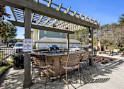 Thumbnail 16 of 39 - A patio area with chairs and a sign that says