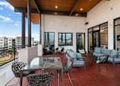 Thumbnail 20 of 26 - A patio with a glass table surrounded by chairs.