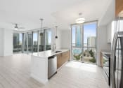 Thumbnail 35 of 66 - a kitchen and living room with a view of the city