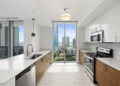 Thumbnail 34 of 66 - a kitchen with white countertops and wooden cabinets