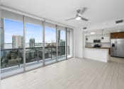 Thumbnail 38 of 66 - a living room with a large window and a view of a city
