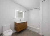 Thumbnail 48 of 66 - a bathroom with a white toilet next to a bathtub with a shower stall