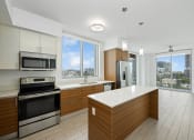 Thumbnail 53 of 66 - a kitchen with white countertops and wooden cabinets