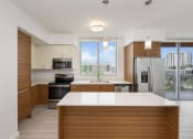 Thumbnail 51 of 66 - a kitchen with white countertops and wooden cabinets