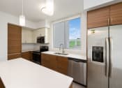 Thumbnail 52 of 66 - a kitchen with white countertops and wooden cabinets