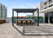 Thumbnail 32 of 66 - a patio with a table and chairs and a mural on the wall