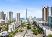 Thumbnail 65 of 66 - a city skyline with tall buildings and a body of water