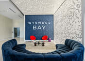 Thumbnail 1 of 66 - a living room with blue couches and a wall with a www wood