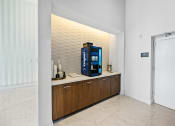 Thumbnail 12 of 66 - a coffee machine on a counter in a room with a door