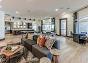 Thumbnail 14 of 28 - A modern living room with a grey sofa and a wooden coffee table.