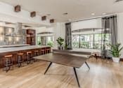 Thumbnail 16 of 28 - A modern kitchen with a wooden island and bar stools.