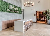 Thumbnail 11 of 28 - A reception area with a green wall and a white reception desk.