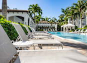 Thumbnail 15 of 47 - A row of sun loungers are on the edge of a pool.