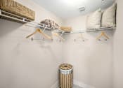 Thumbnail 45 of 47 - A white closet with a shelf and a trash can.